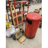 A RED LITTER BIN AND A SACK TRUCK