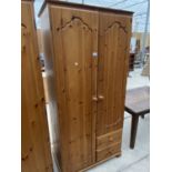 A PINE WARDROBE WITH TWO DOORS AND TWO DRAWERS