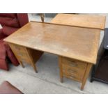 AN OAK DESK WITH SIX DRAWERS