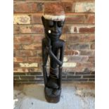 A 1950'S TALL WOODEN CARVED TRIBAL FIGURE