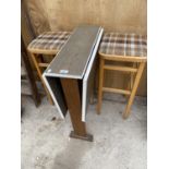 A RETRO TEAK DROP LEAF KITCHEN TABLE AND TWO KITCHEN STOOLS