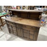 AN F D WELTERS OAK SIDEBOARD WITH TWO DOORS, THREE DRAWERS AND SPLASHBACK