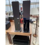 TWO 'Q ACQUISTICS' FLOOR SPEAKERS (NO PLUGS) TOGETHER WITH A GLASS ENTERTAINMENT STAND