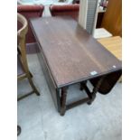 AN OAK DROP LEAF DINING TABLE ON BARLEY TWIST SUPPORTS