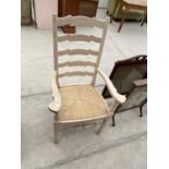 A BEECH LADDER BACK CARVER ARMCHAIR WITH RUSH SEAT