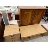 FOUR ITEMS - A PINE EFFECT BEDSIDE CHEST OF THREE DRAWERS, A CD RACK, AN OAK COFFEE TABLE AND A
