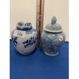 TWO BLUE AND WHITE PAINTED LIDDED JARS ONE A/F (CRACK)