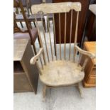 A HIGH BACKED OAK ROCKING CHAIR