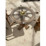 A SHIP'S WHEEL COFFEE TABLE WITH GLASS TOP