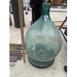 A VINTAGE GREEN GLASS CARBOY ON STAND
