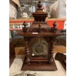 AN ORNATE WOODEN CLOCK