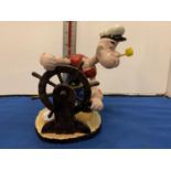 A CAST IRON POPEYE WITH A SHIPS WHEEL FIGURE