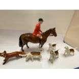 A BESWICK HUNTSMAN ON HORSEBACK, FOUR FOX HOUNDS AND A FOX