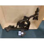 A CAST IRON DECORATIVE WALL BRACKET