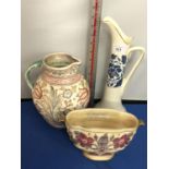 A CHARLOTTE RHEAD CROWN DUCAL TALL BLUE TALL JUG, ANOTHER BALUSTER JUG AND A FLORAL DECORATED VASE