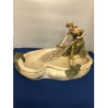 A ROYAL DUX TABLE CENTREPIECE OF SEATED FEMALE HAULING A FISHING NET AND FISH, 24.5 X 43 CM