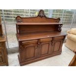 A MAHOGANY SIDEBOARD WITH THREE DOORS, THREE DRAWERS AND UPPER SPLASHBACK WITH SHELF AND CARVED