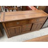 AN OAK CAMPAIGN STYLE SIDEBOARD WITH TWO SLIDING DOORS AND FIVE DRAWERS