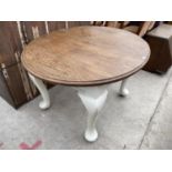 AN OVAL OAK DINING TABLE ON WHITE CABRIOLE SUPPORTS