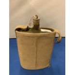 A CANVAS COVERED ARMY DRINKING BOTTLE WITH CORK STOPPER