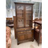 A MAHOGANY BOOKCASE CABINET WITH TWO DOORS, TWO DRAWERS AND TWO UPPER GLAZED DOORS