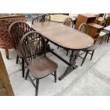 AN OAK DINING TABLE AND FOUR OAK WHEELBACK DINING CHAIRS