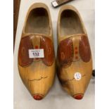 A PAIR OF DECORATIVE WOODEN CLOGS