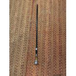 A WOODEN AND WHITE METAL WALKING CANE