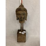 AN ANTIQUE STYLE STONE BUDDHA HEAD ON STEEL PLINTH 30CM