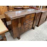 AN OAK SIDEBOARD WITH TWO DOORS AND FOUR DRAWERS