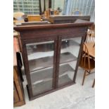 A CRAVED MAHOGANY CABINET WITH TWO GLAZED DOORS