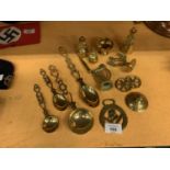 A COLLECTION OF BRASSWARE TO INCLUDE SPOONS, WELSH LADIES, HARP, WHEELS ETC