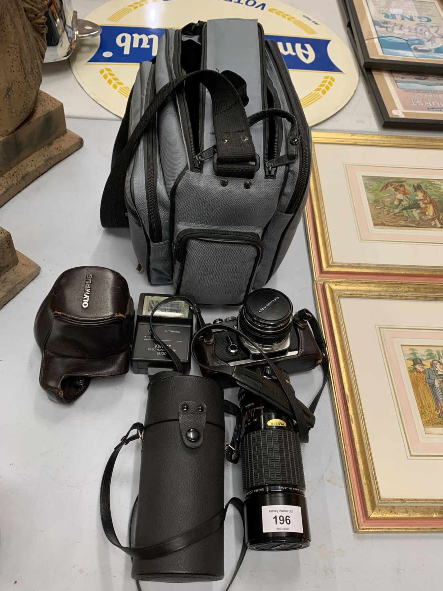 AN OLYMPUS CAMERA WITH FLASH, LENS AND BAG