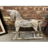 A WHITE PAINTED WOODEN ROCKING HORSE, TAIL AF