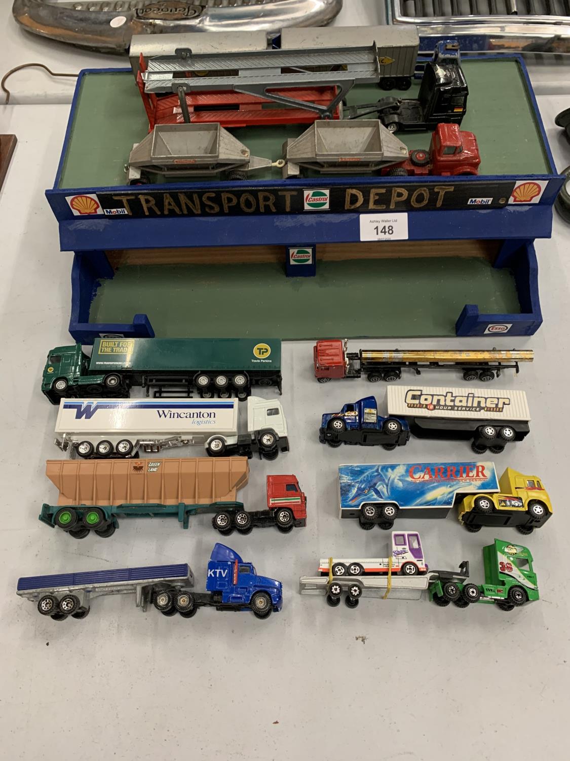 A WOODEN TOY TRANSPORT DEPOT WITH TWELVE MODEL LORRIES