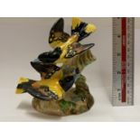 A BESWICK PAIR OF SONGBIRDS ON A BRANCH