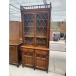 A THOMAS GLENISTER MAHOGANY BOOKCASE CABINET WITH TWO DOORS, TWO DRAWERS, TWO UPPER LEAD GLAZED