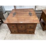 AN INDONESIAN WOOD COFFEE TABLE WITH SIX SMALL DRAWERS