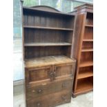 AN OAK DRESSER WITH TWO DOORS, TWO DRAWERS AND UPPER PLATE RACK