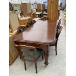 A MAHOGANY EXTENDING DINING TABLE WITH TWO EXTRA LEAVES WITH EIGHT BALLOON BACK DINING CHAIRS