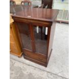 A MAHOGANY STEREO CABINET WITH TWO GLAZED DOORS