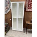 A TALL WHITE CABINET WITH TWO GLAZED DOORS