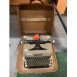 A VINTAGE DIPLOMAT TYPEWRITER IN A CASE WITH RIBBON TIN