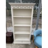 A WHITE FOUR TIER BOOKCASE WITH TWO LOWER DRAWERS