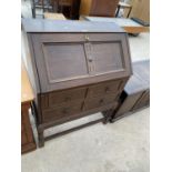 AN OAK BUREAU WITH FALL FRONT AND TWO DRAWERS