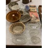 TWELVE ASSORTED VINTAGE JELLY MOULDS AND SEVERAL COOKERY BOOKS