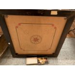 A LARGE VINTAGE WOODEN FRAMED CARROM BOARD WITH A BOX OF COUNTERS