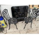 TWO CAST METAL CHAIRS AND A GARDEN TABLE