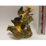 A BESWICK PAIR OF SONGBIRDS ON A BRANCH