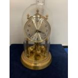 A VINTAGE FHS GERMANY '921-001' BRASS CLOCK WITH GLASS DOME